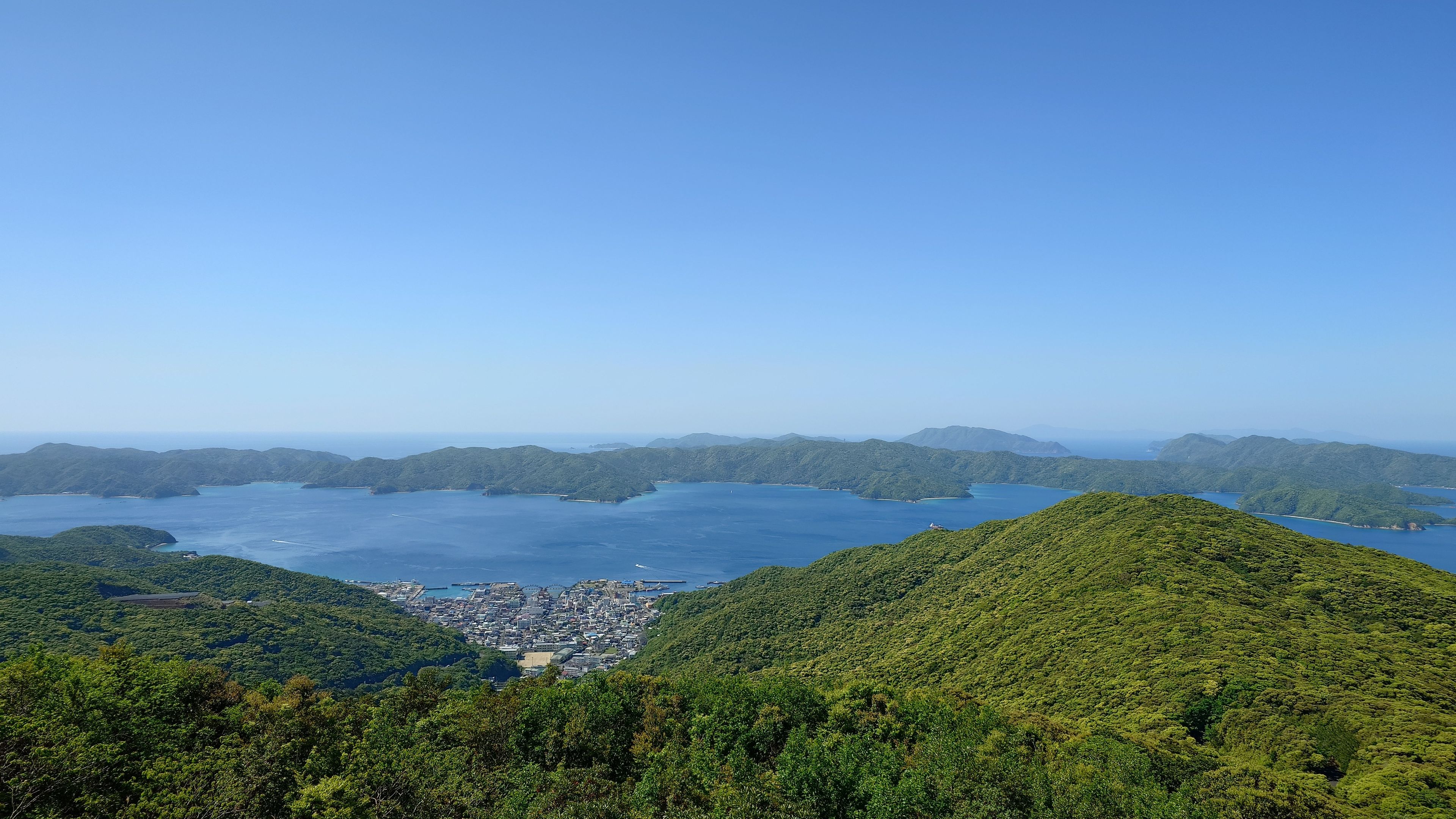 The village of Setouchi sitting in a valley with Kakeroma Island beyond