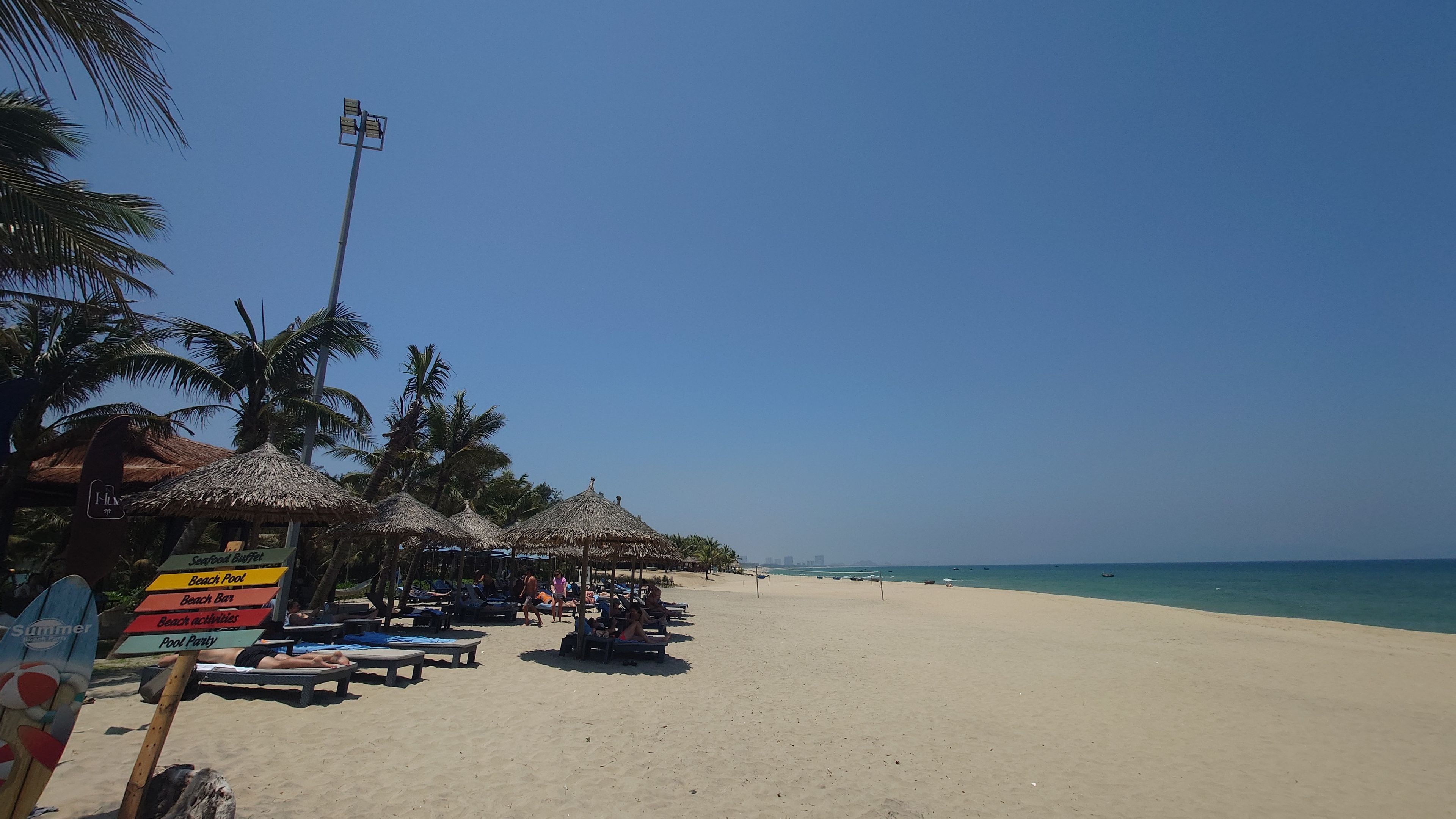 Full view of An Bang Beach during the day with umbrellas