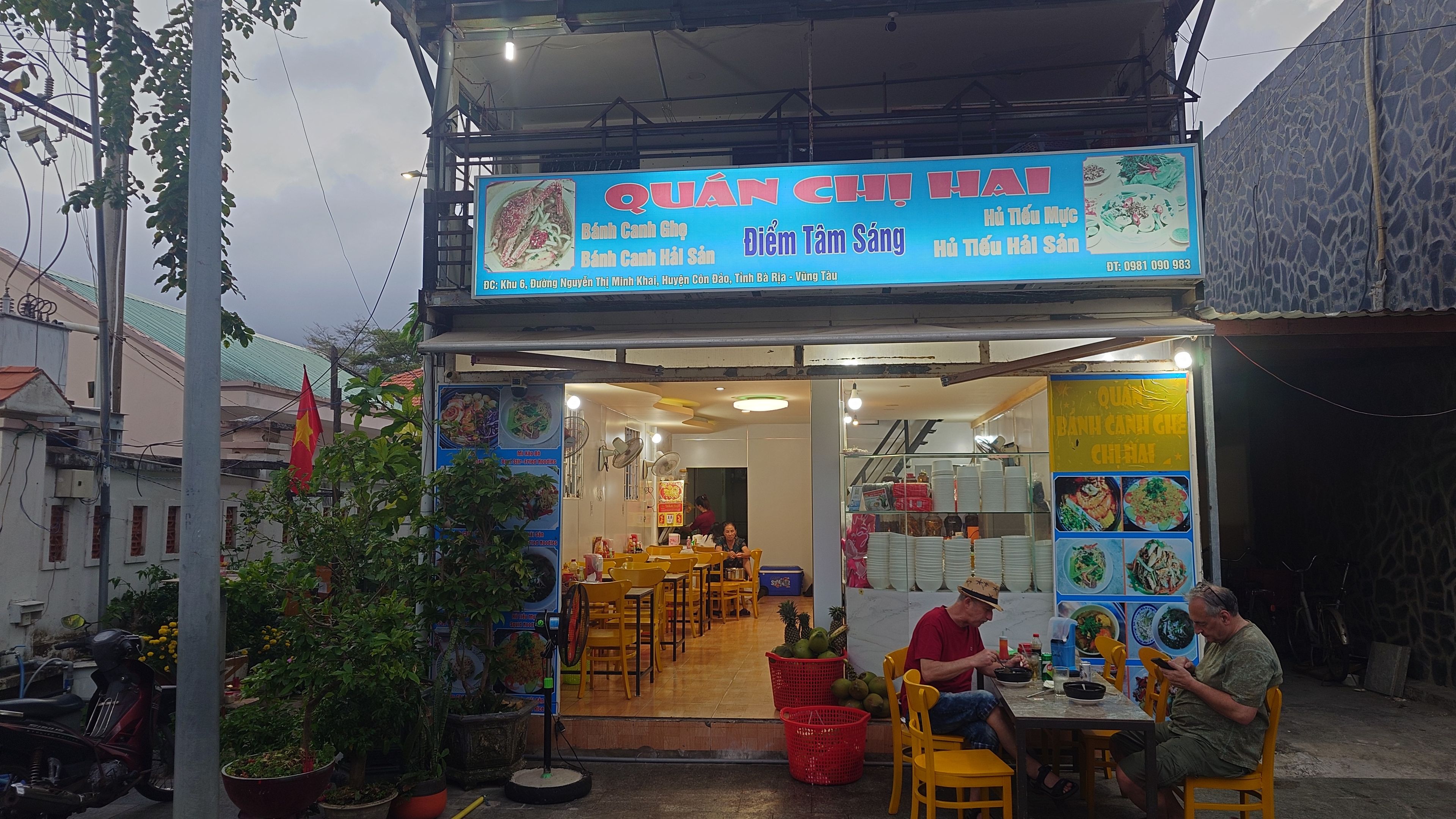 The shop exterior with its blue sign