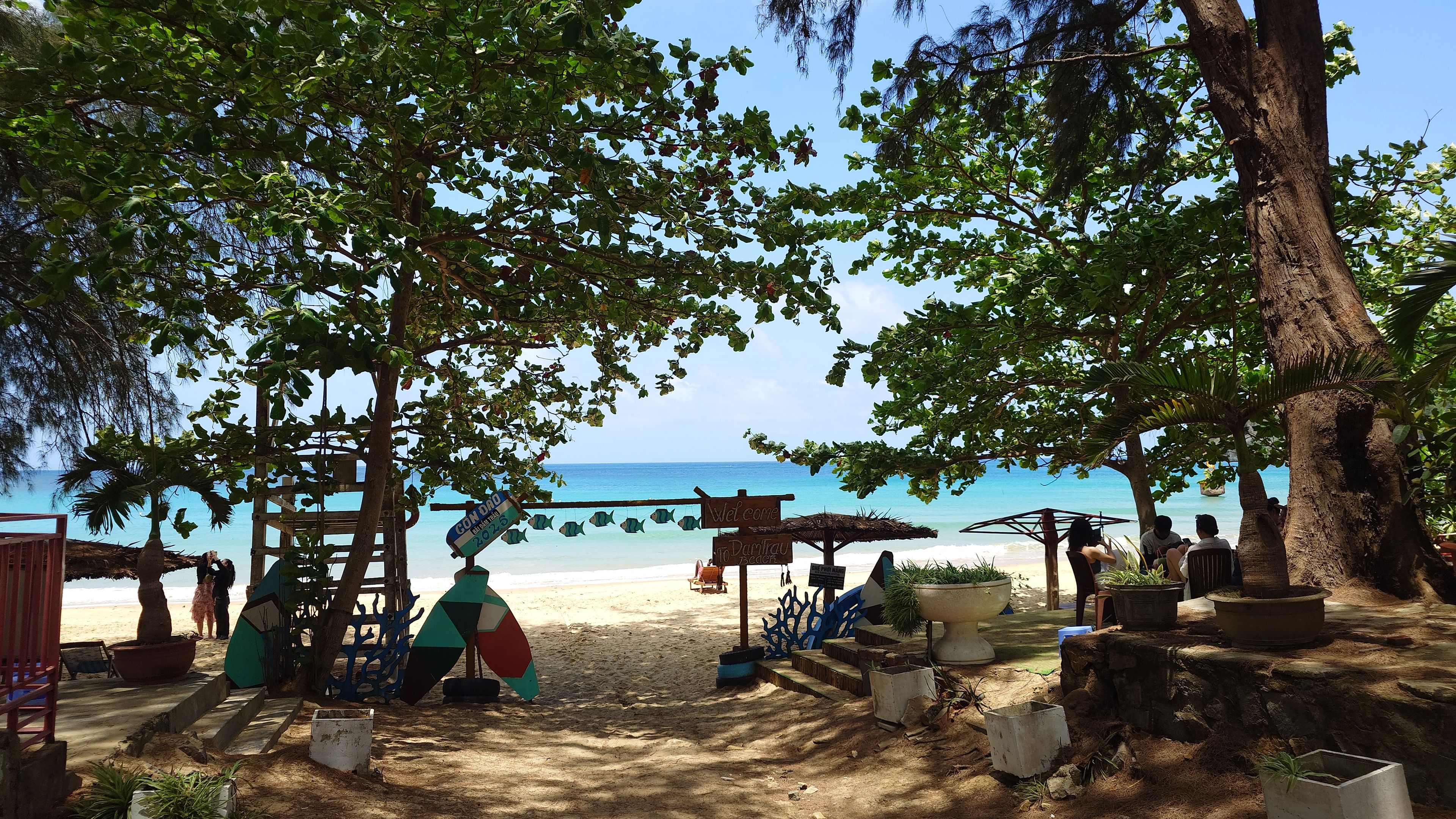 A plane passing overhead at a low altitude over Dam Trau Beach