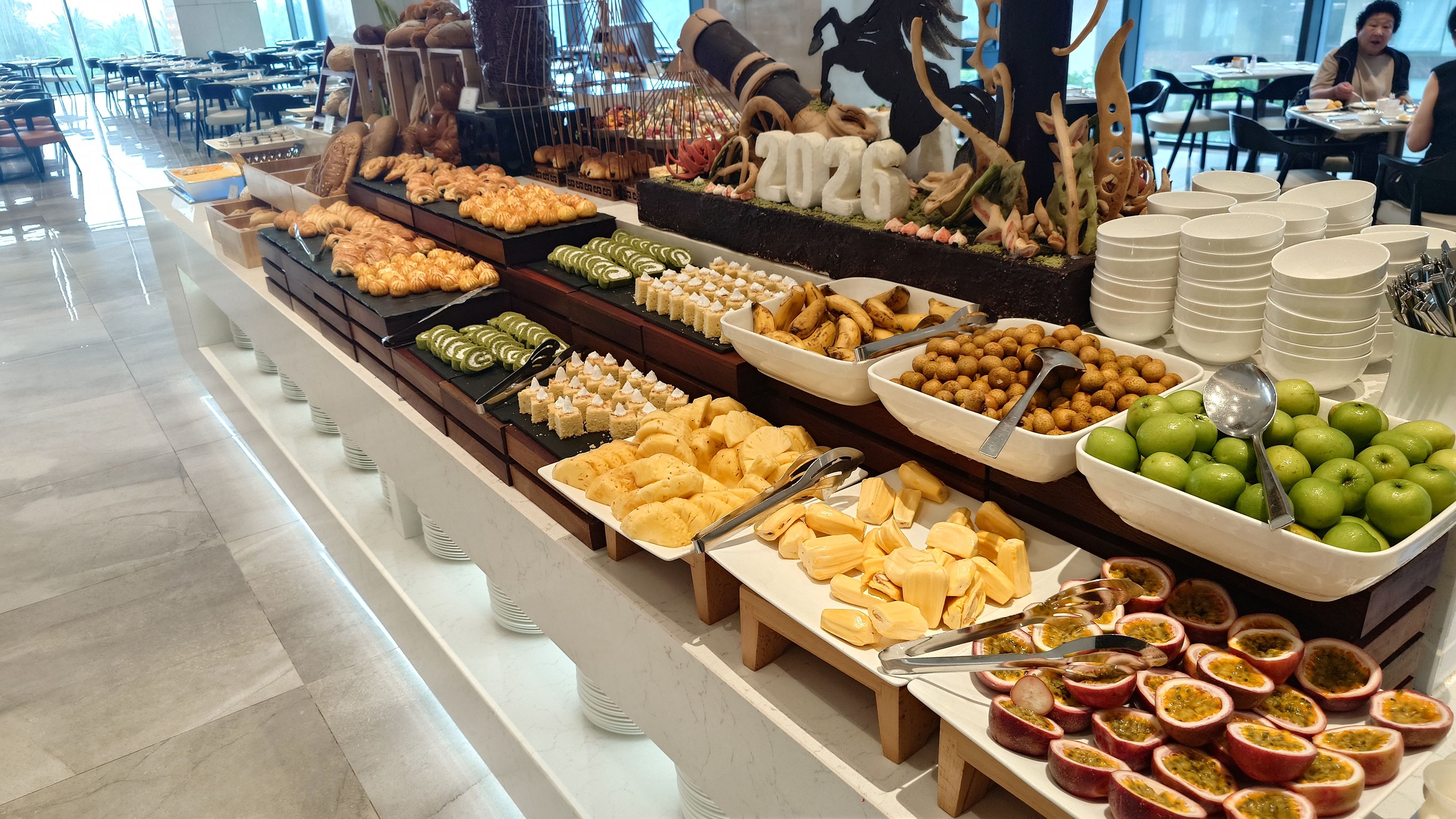Breakfast buffet with colorful tropical fruits and pastries