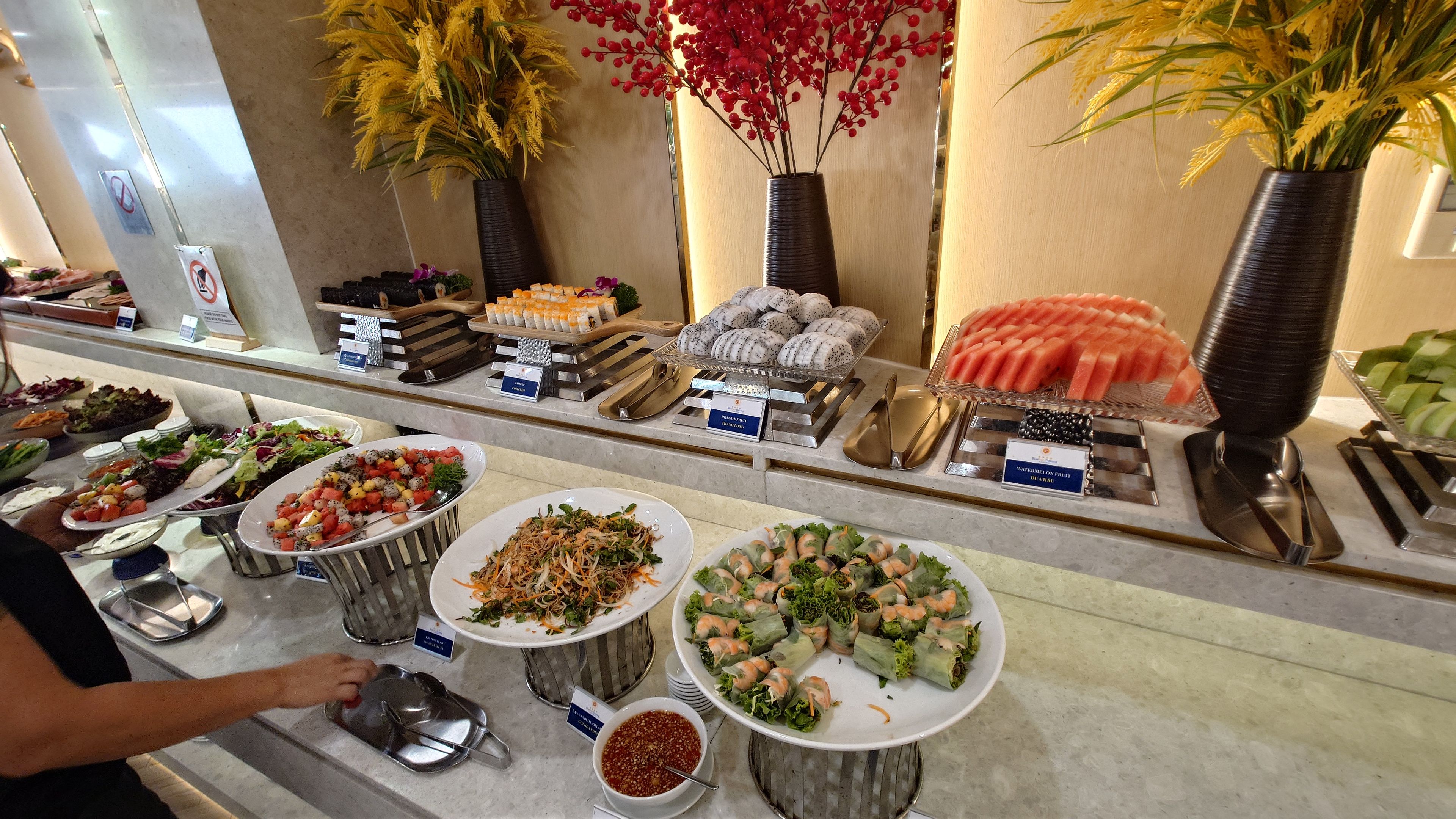 Breakfast buffet featuring fresh spring rolls and sushi