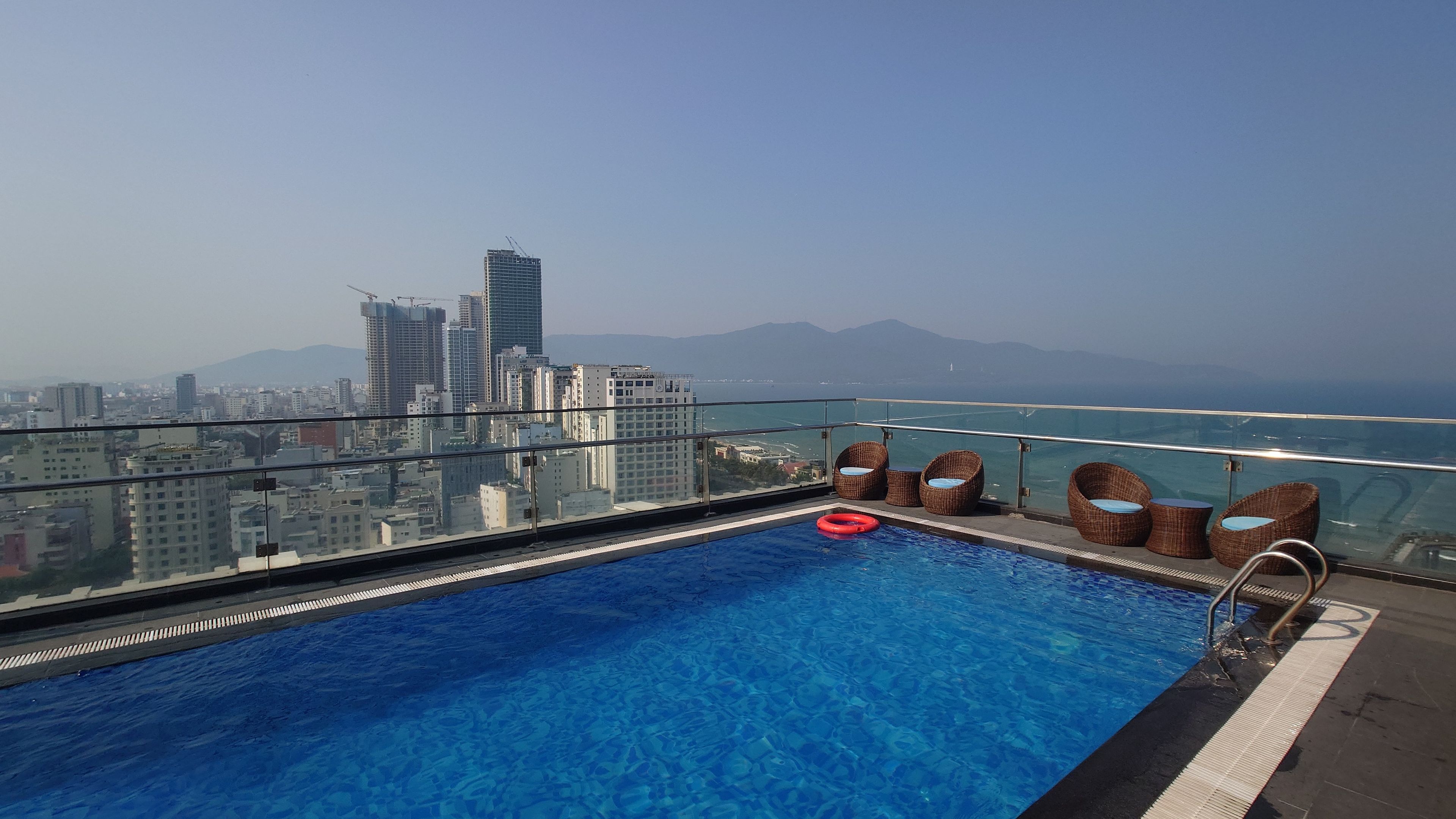 Rooftop infinity pool overlooking My Khe Beach and city skyline