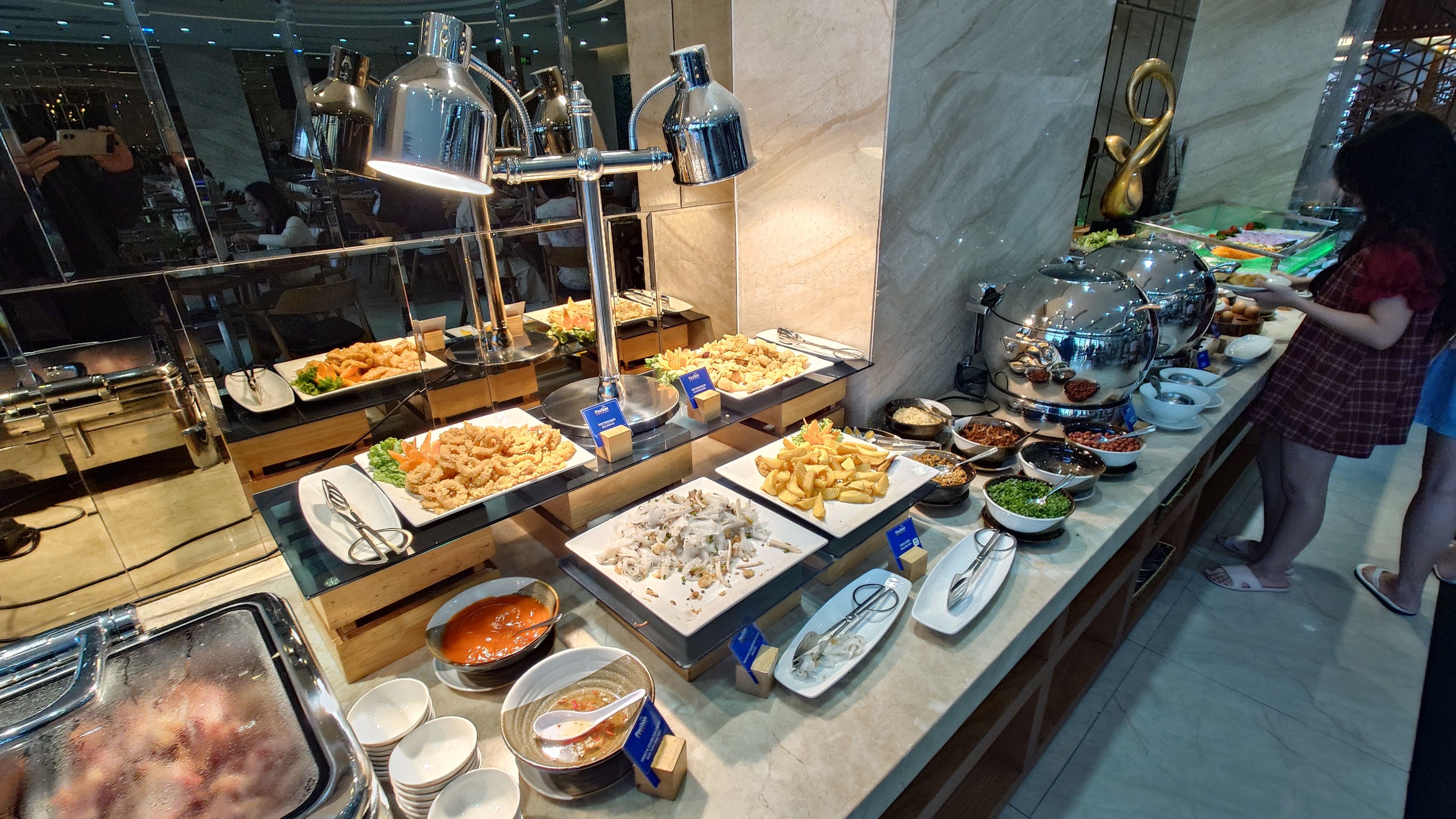 Breakfast buffet featuring hot dishes and traditional congee